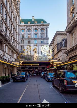 Exterior façade of The Savoy Hotel with illuminated Christmas decorations above the silver canopy. London. Stock Photo