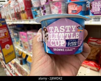 Augusta, Ga USA - 04 15 22: Hand holding Tasty little cup brownie Stock Photo
