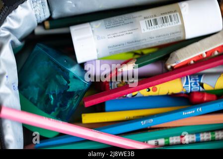 Warsaw, Poland - May 4, 2022: Crayons in a pencil case. Student equipment for school, colored pencils scattered in the pencil case. Stock Photo