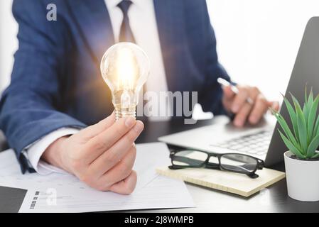 Business, creative idea concept. Businessman holding light bulb Stock Photo