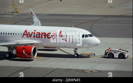 An Avianca Airlines Airbus A320 passenger planeis towed from a gate at San Francisco International Airport in San Francisco, California. Stock Photo