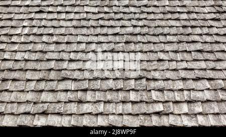 Perspective of old grey brown wooden tile roof background Stock Photo