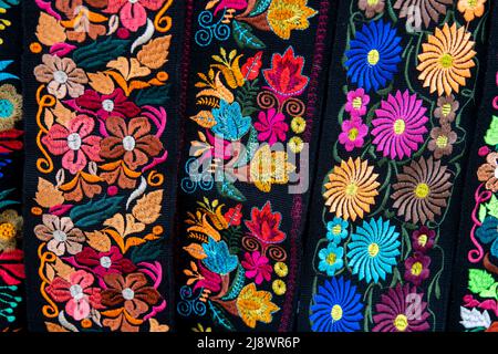 Ecuador, Quito. Otavalo market. Traditional Ecuadorian textiles, colorful embroidery with flowers. Stock Photo