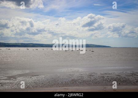 View of the North Wales coast from West Kirby, with sail boast on the River Dee Estuary Stock Photo