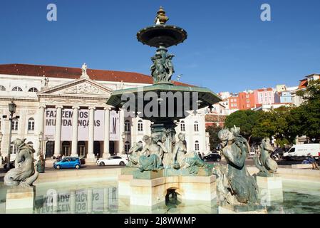 Lisbon, Portugal - July 8, 2021: North fountain in the Rossio Square, Queen Maria II National Theatre in the background, Lisbon, Portugal Stock Photo