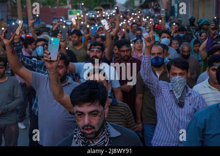 Srinagar, India. 17th May, 2022. Kashmiri Hindus, locally known as 'pandits' hold mobile flashlights during the protest in Budgam against the killing of Rahul Bhat a government employee who was shot dead by suspected Rebels inside his office in Chadoora Budgam. While the Indian authorities assured the Kashmiri Pandit community that all jobs and security related issues will be resolved in a week's time, the community demands transfer from the Kashmir region as early as possible, saying that they can't risk their life for jobs. Credit: SOPA Images Limited/Alamy Live News Stock Photo