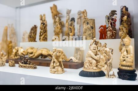 Buddha figurines in showcase. Museum of ethnology, Barcelona, Spain Stock Photo
