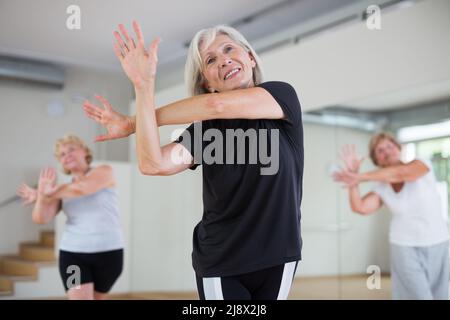 Portrait of an elderly dancing woman practicing vigorous swing Stock Photo