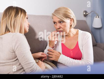 daughter comforts a sad mother Stock Photo