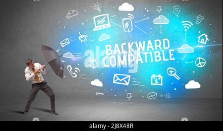 Businessman defending with umbrella, modern technology concept Stock Photo