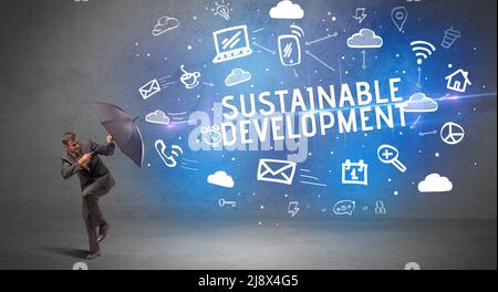 Businessman defending with umbrella, modern technology concept Stock Photo