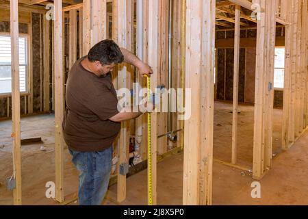 Hands of electrician installing electrical socket in new apartment Stock Photo