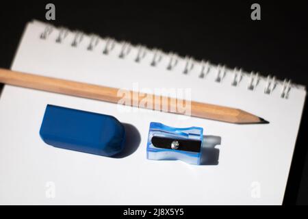 Notebook, pencil, eraser, and sharpener Stock Photo