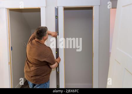 Renovation home on carpenter at interior wood door installation working Stock Photo