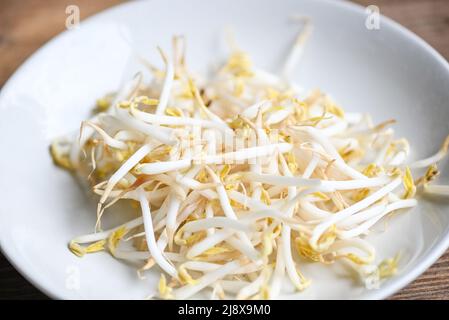 Bean sprouts on white plate table background in the kitchen, Raw white organic bean sprouts or mung bean sprout for food vegan Stock Photo