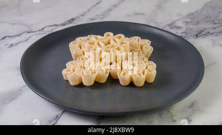 Malaysian Kuih Raya called Kuih Goyang or Kuih Ros. Popular traditional kuih raya on Hari Raya Aidilfitri in Malaysia. Stock Photo