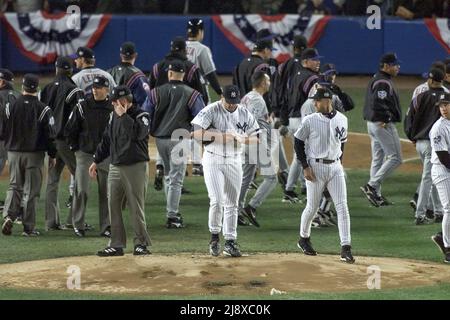 New York Mets batter Mike Piazza, left, confronts New York Yankees pitcher  Roger Clemens after he threw a bat during World Series Game 1 at Yankees  Stadium in New York on October