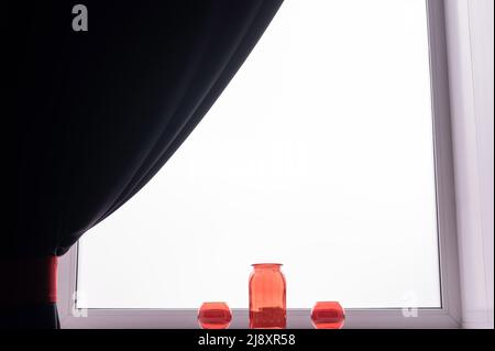 Three empty glass red vases on the windowsill.  Stock Photo