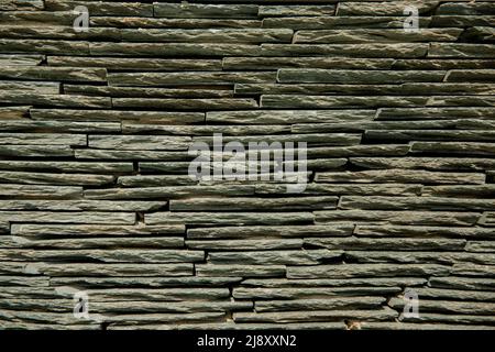 A full frame background of layers of slate from Honister Slate Mine in The Lake District National Park with copy space Stock Photo