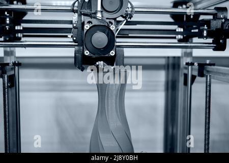 Process printing model on 3d printer. High tech digital printer computer machine in action. Printing mechanism adding layers to object. FDM 3d printer working at 3d printing lab. 3D modern technology. Stock Photo