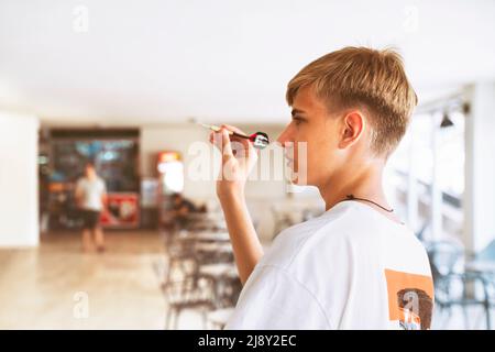 young man plays darts outdoors. Leisure concept. Stock Photo