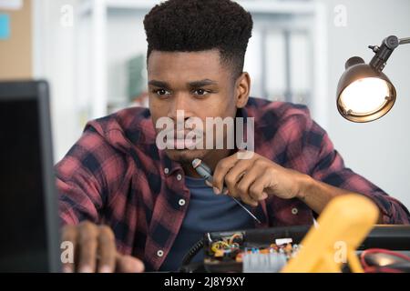 portrait of man fixing pc Stock Photo