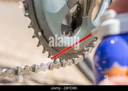 Care of the bicycle chain through regular cleaning and oiling Stock Photo