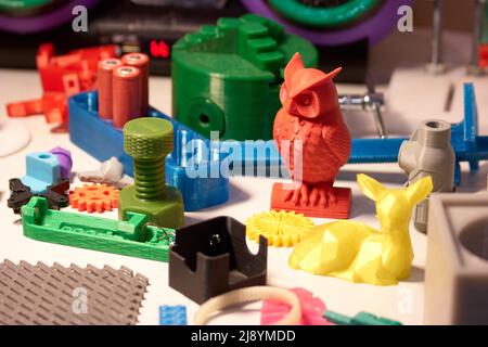 Collection of bright colorful objects printed on a 3d printer. Variety of plastic products manufactured by 3D printing. Stock Photo