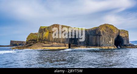 Panoramic view of dramatic sea cliffs of Staffa, with Fingal’s Cave on right, approached from the sea - Isle of Staffa, Inner Hebrides, Scotland, UK Stock Photo