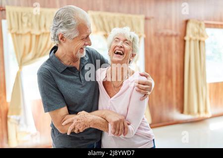 Senior couple in love having fun and laughing together as concept of friendship and love in old age Stock Photo
