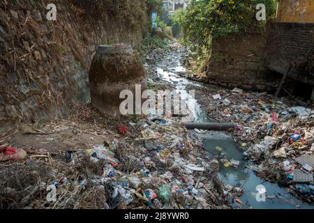 A sewer full of plastic and toxic waste flowing in open. Dehradun, uttarakhand India. Stock Photo