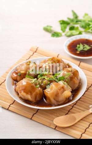 Close up of Bawan (Ba wan), Taiwanese meatball delicacy, delicious street food, steamed starch wrapped round shaped dumpling with pork and shrimp insi Stock Photo