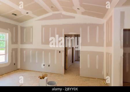 Finishing plastering drywall in ready for paint with new house Stock Photo