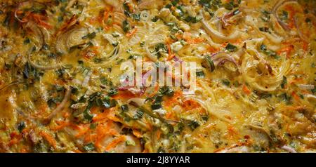 Pie made from fish, eggs, onions and carrots. Texture, background. Stock Photo