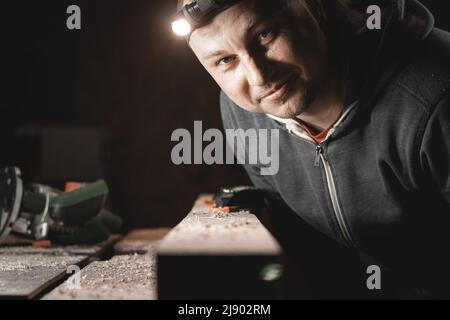 Portrait of smiling young carpenter working in his workshop. Stock Photo