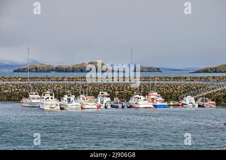 Stykkisholmur, Iceland, May 3, 2022: little boats moored in the town's harbour with Breidarfjordur and its many islands in the background Stock Photo