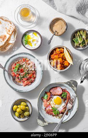 Healthy Turkish breakfast spread in the bright morning, white background Stock Photo