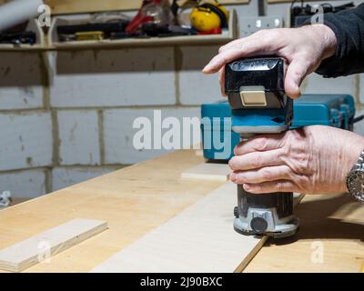 close up focus of hand held cordless battery powered trimming router Stock Photo
