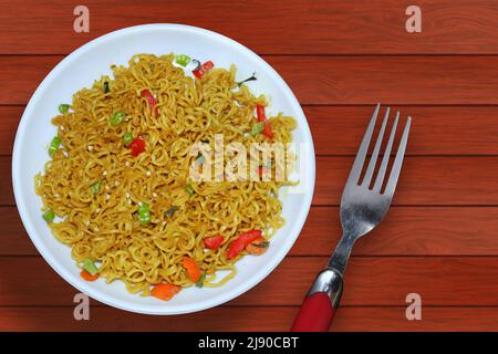 Top view Instant noodles on a white plate on a wooden backgrounds Stock Photo