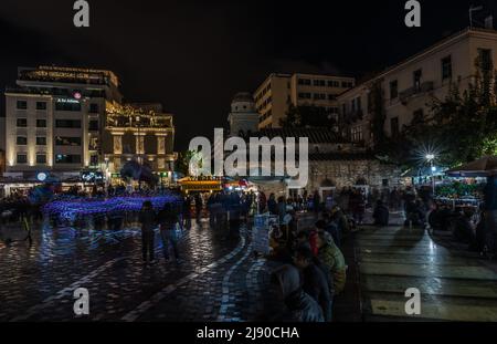 Athens Old Town, Attica, Greece - 12 28 2019 Locals and tourists walking over the Monastiraki Square by night Stock Photo