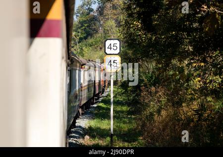 The traffic sign shows the train's limited speed, climbing to the high mountain with the diesel-electric locomotive, northern Thailand, front view for Stock Photo