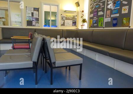 Seating and displays inside the doctor's surgery waiting room without people. Stock Photo