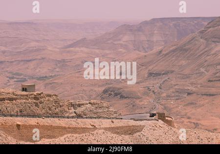 The King’s Highway Road in Jordan as it winds down through desert mountains towards Petra Stock Photo