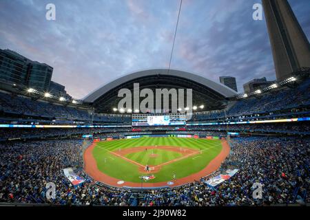 Toronto, Canada, May 3, 2022, Toronto Blue Jays catcher Alejandro Kirk (30)  slide safe to scores a run at home plate past New York Yankees catcher Jose  Trevino (not shown) during fifth