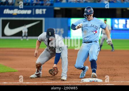 Seattle Mariner infielder Ty France (23) attempt tag out Toronto Blue Jay infielder  Matt Chapman(26) during an MLB game between Seattle Mariners and Stock Photo