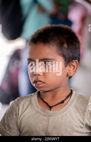 indian child beggar is in a railway station. Concept- child education. Stock Photo