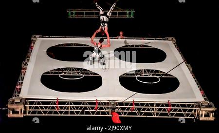 May 17, 2022, Izmir, Turkey, Turkey: As part of the International 40 th Izmir Theater Festival famous Italian performance team 'Eventi Verticali' has performed ' Quadro' top of the Gundogdu Square. The four dancers have combined elements of theatre, circus, acrobatics, dance and music. Artists have performed in acrobatic leaps, moving over and around the suspended white stage that hanged on a crane. The white platform slowly has changed position along the way in vertical in the dark night and has composed the sense of movement outer space for audiences. (Credit Image: © Idil Toffolo/Pacific Pr Stock Photo