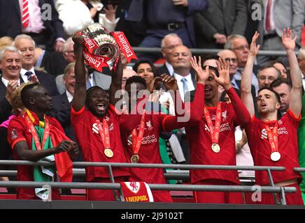 Liverpool's Naby Keita (second left) lifts the trophy following the Emirates FA Cup final at Wembley Stadium, London. Picture date: Saturday May 14, 2022. Stock Photo