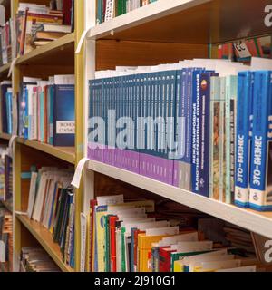 Chapaevsk, Samara region, Russia - December 24, 2020: Books on a shelf in the library. Selective focus Stock Photo