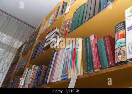 Chapaevsk, Samara region, Russia - December 24, 2020: Books on a shelf in the library. Selective focus Stock Photo
